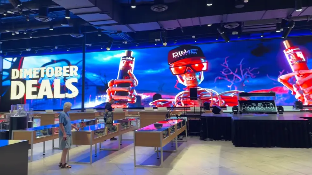 Planet 13 in-store LED wall showing Dimetober Deals above the sales floor