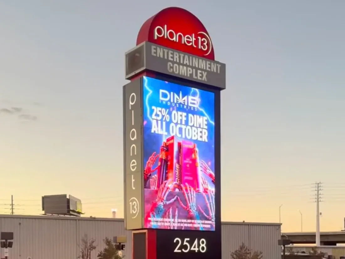Planet 13 outdoor pylon sign with a large LED screen showing 25% off Dime all October